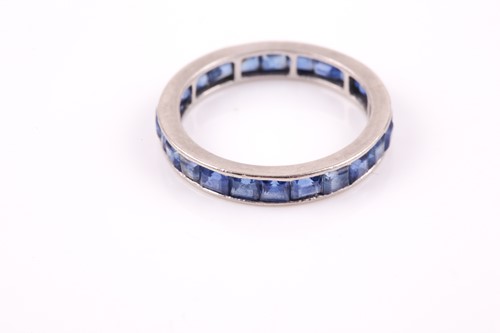 Lot 90 - A white metal and sapphire full eternity ring,...