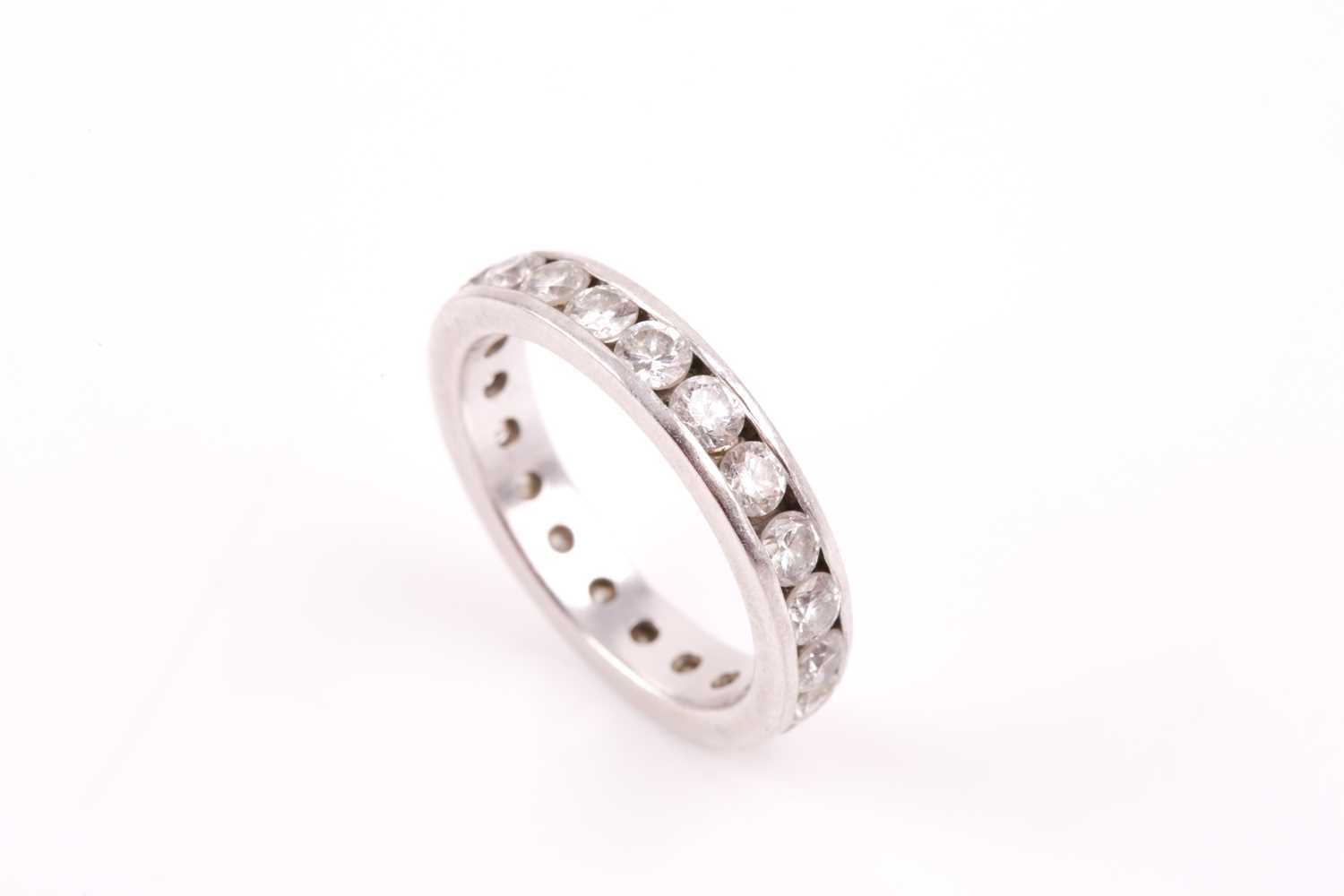 Lot 116 - A platinum and diamond eternity ring, set with...