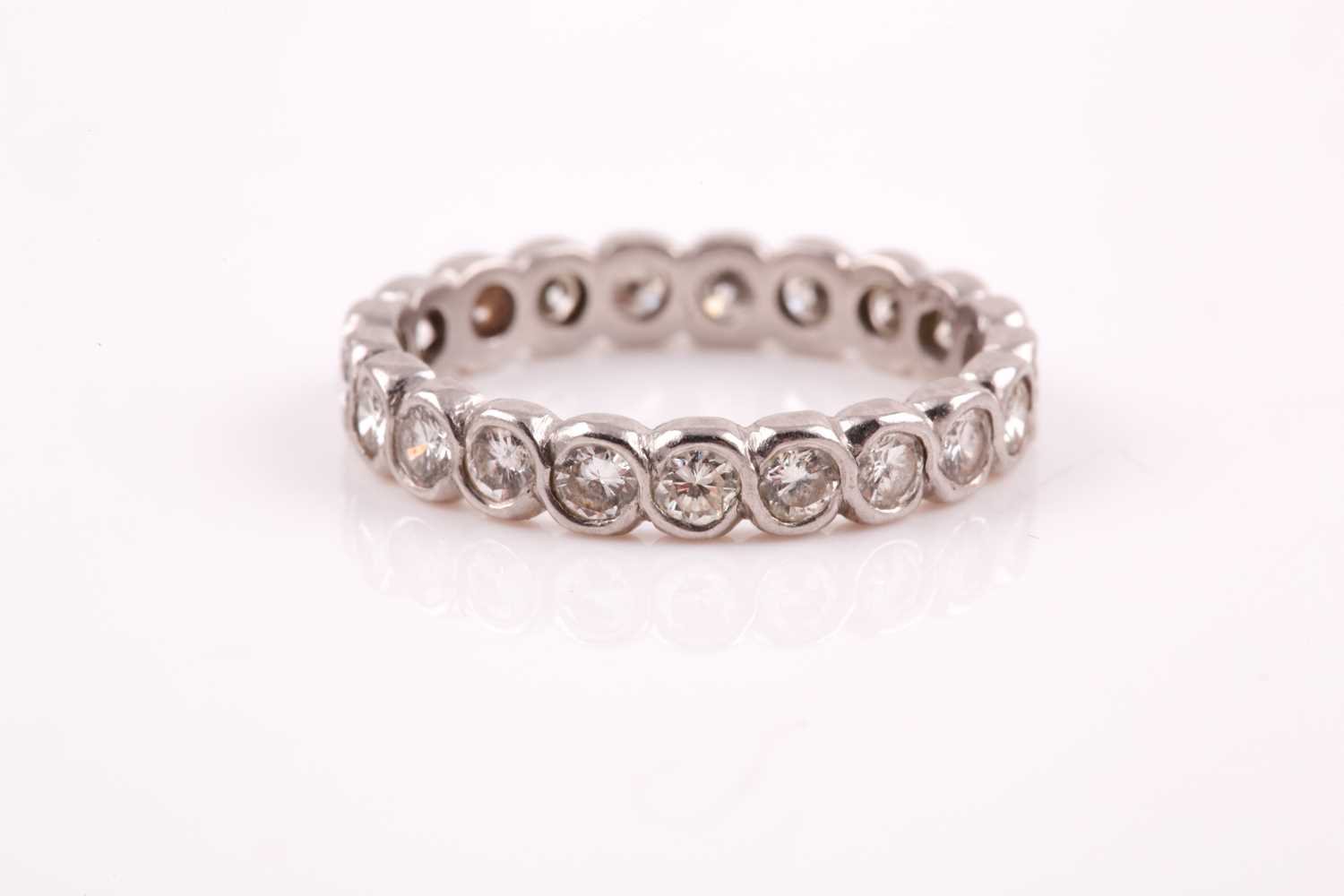 Lot 41 - A diamond eternity ring, rubover set with...