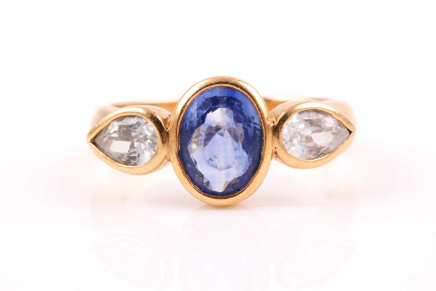 Lot 194 - A yellow metal and sapphire ring, rubover-set...