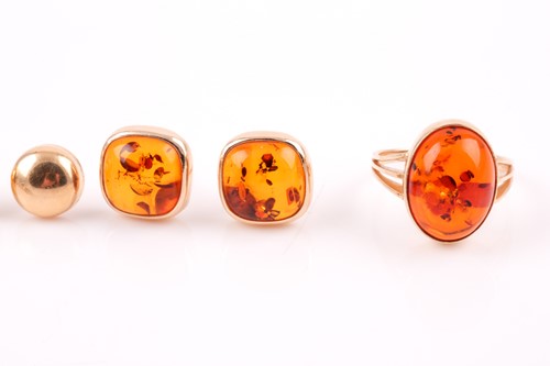 Lot 152 - A yellow metal and pressed amber ring, the...