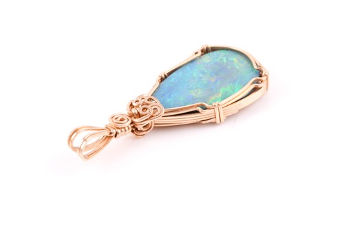 Lot 206 - A yellow metal and doublet opal pendant, the...
