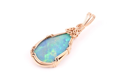 Lot 206 - A yellow metal and doublet opal pendant, the...
