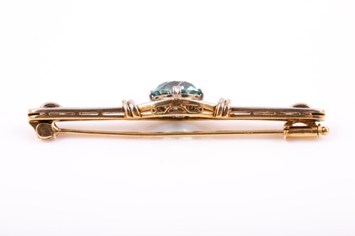 Lot 104 - A white and yellow gold and blue zircon brooch,...