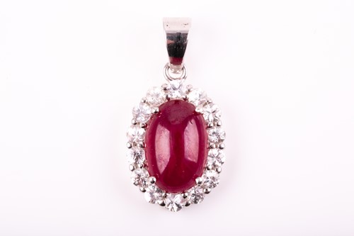 Lot 36 - A silver, ruby, and white sapphire pendant of...