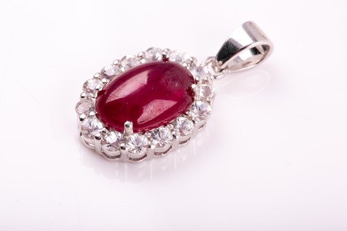 Lot 36 - A silver, ruby, and white sapphire pendant of...