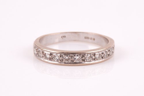 Lot 327 - A diamond half hoop eternity ring; the round...