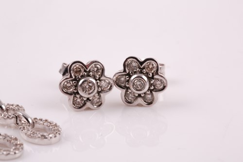 Lot 59 - A pair of 9ct white gold and diamond floral...