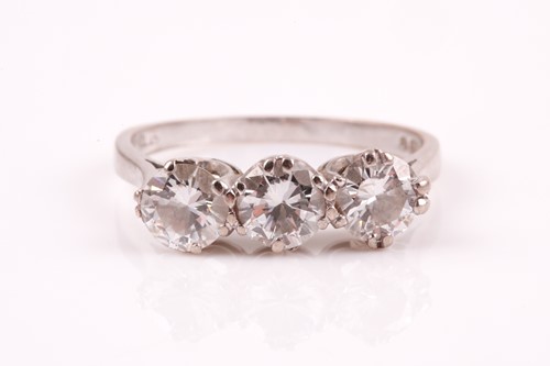 Lot 309 - A three stone diamond half hoop ring, the...