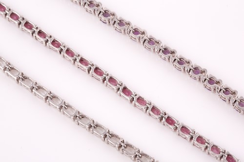 Lot 123 - A silver and amethyst line bracelet, together...