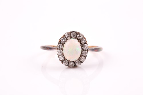 Lot 403 - A diamond and opal cluster ring, set with an...
