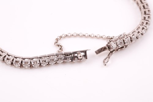 Lot 147 - A diamond line bracelet, set with round...
