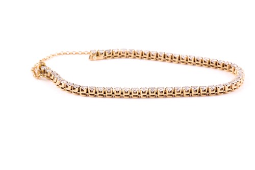 Lot 163 - An 18ct yellow gold and diamond line bracelet,...