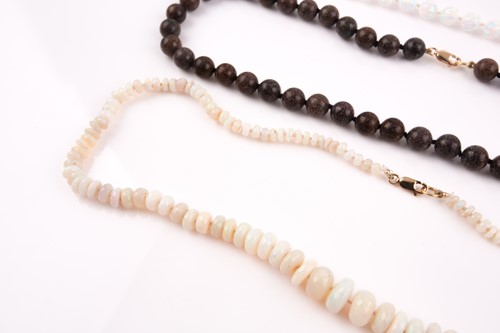 Lot 149 - A faceted opal bead necklace, together with a...