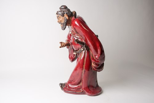 Lot 105 - A Shiwan flambe glaze figure of Guandi, mid...