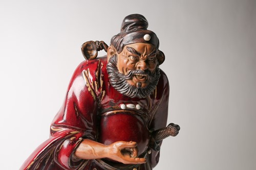 Lot 105 - A Shiwan flambe glaze figure of Guandi, mid...