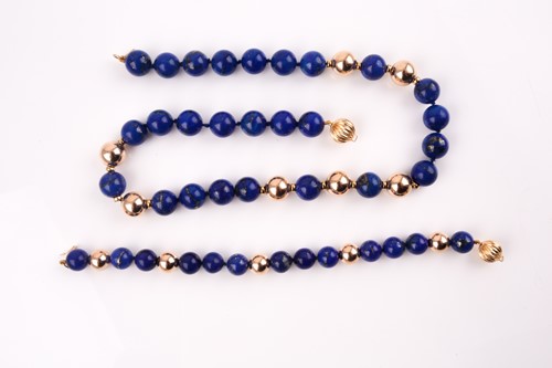 Lot 80 - A lapis and yellow metal beaded necklace, set...