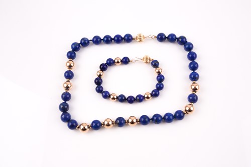 Lot 80 - A lapis and yellow metal beaded necklace, set...