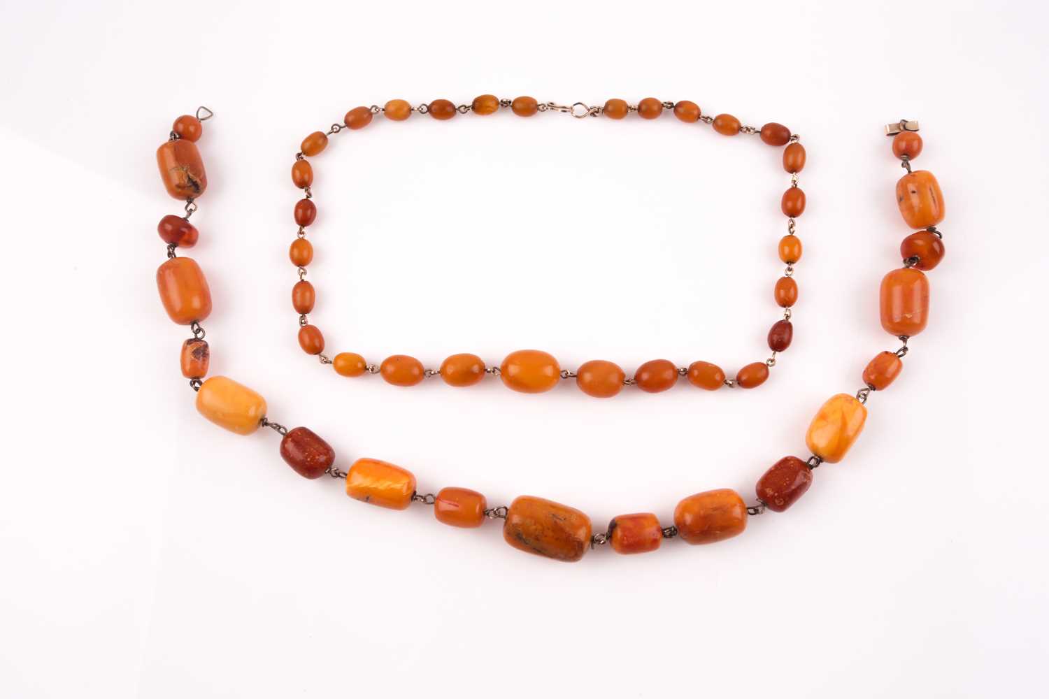 Lot 133 - A buttercotch amber and gilt metal necklace...