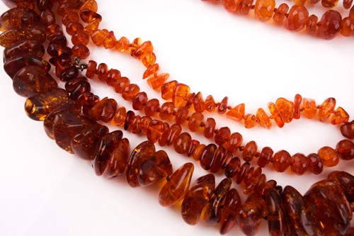 Lot 110 - A treated amber necklace, of naturalistic...