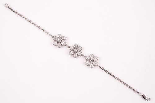 Lot 491 - A diamond floral cluster bracelet, set with...