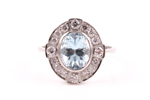 Lot 436 - A diamond and aquamarine cluster ring. the...