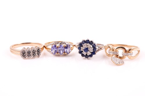Lot 426 - A diamond and sapphire three tier cluster ring...