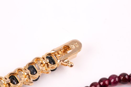 Lot 185 - A silver gilt and sapphire line bracelet, set...