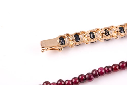 Lot 185 - A silver gilt and sapphire line bracelet, set...