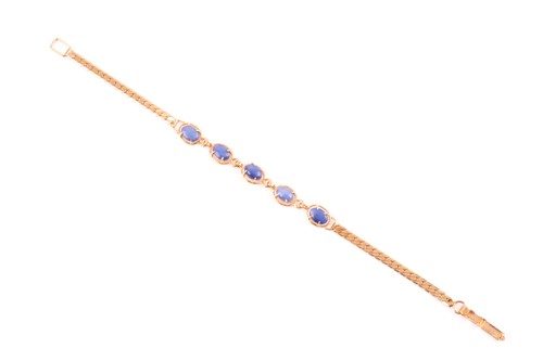 Lot 345 - A gilt metal and star sapphire bracelet, set...