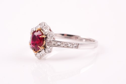 Lot 224 - A ruby and diamond cluster ring, the cushion...