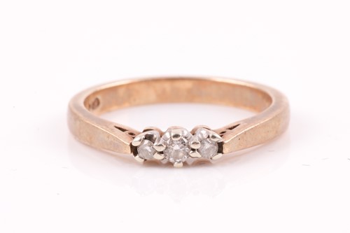 Lot 423 - A three stone half hoop diamond ring, the...