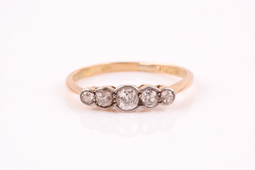 Lot 492 - A five stone diamond half hoop ring; the...