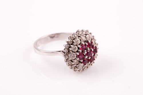 Lot 219 - A white metal diamond and ruby cluster ring,...
