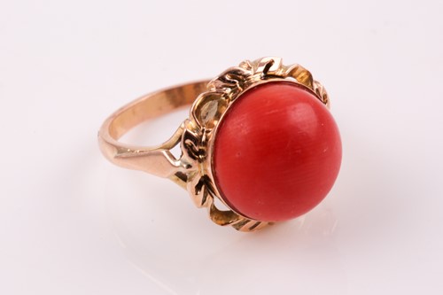 Lot 135 - A Continental yellow metal and coral ring, set...