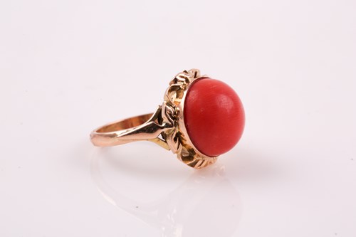 Lot 135 - A Continental yellow metal and coral ring, set...