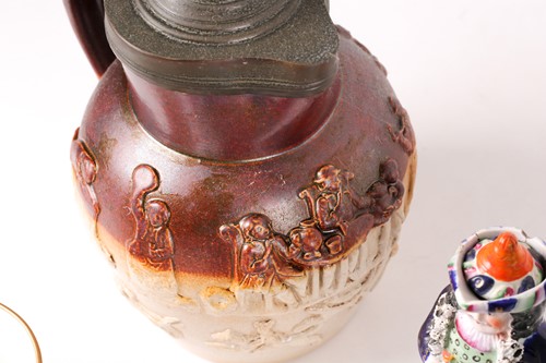 Lot 444 - A Mettlach half litre stein, the lid decorated...