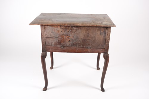 Lot 207 - An early 18th-century oak kneehole lowboy with...