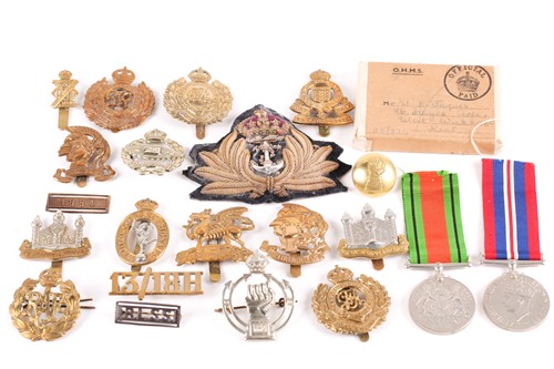 Lot 361 - A small collection of military cap badges, to...