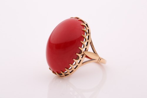 Lot 60 - A yellow metal and red coral ring, set with an...