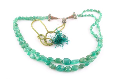 Lot 133 - An Indian emerald beaded necklace, the two...