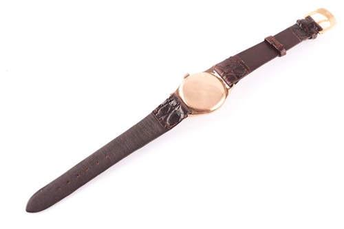Lot 523 - A gents yellow metal Cyma watch, the round...