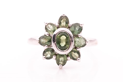 Lot 359 - A 9ct white gold and green sapphire floral...