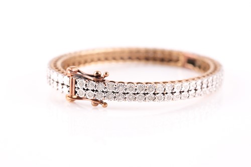 Lot 231 - A diamond set baby's bangle, the centre with...