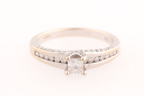 Lot 354 - A single stone diamond ring; the central...
