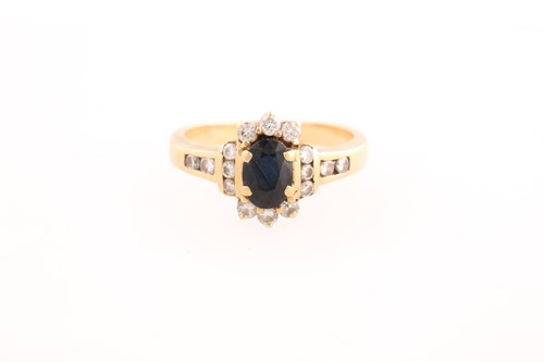 Lot 220 - A sapphire and diamond cluster ring; the...