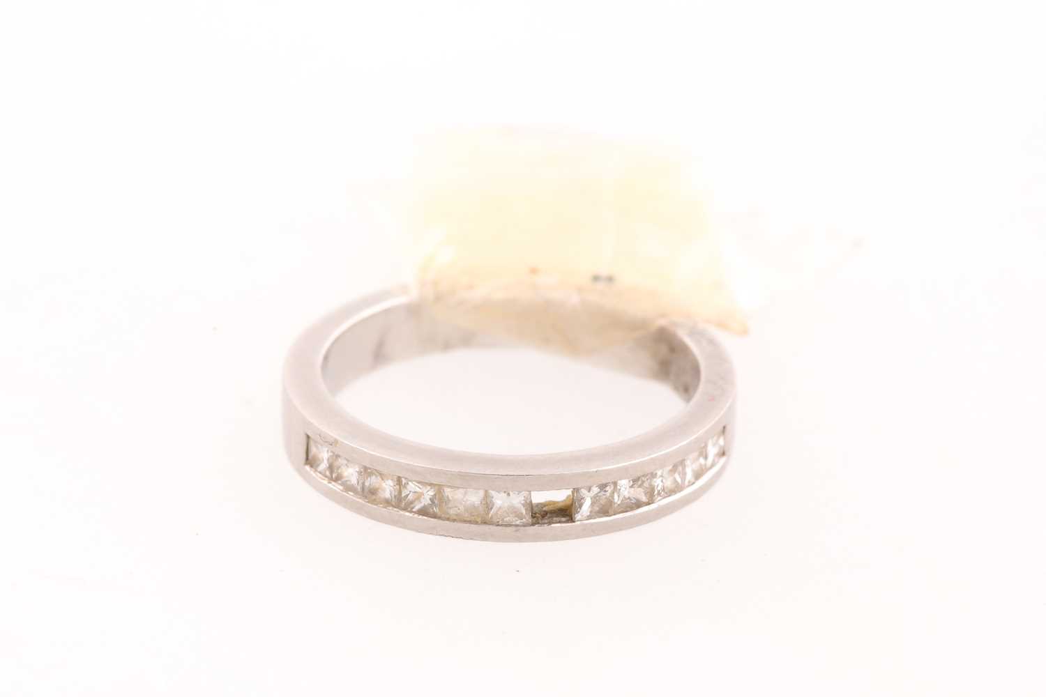 Lot 106 - A diamond half hoop eternity ring; channel set...