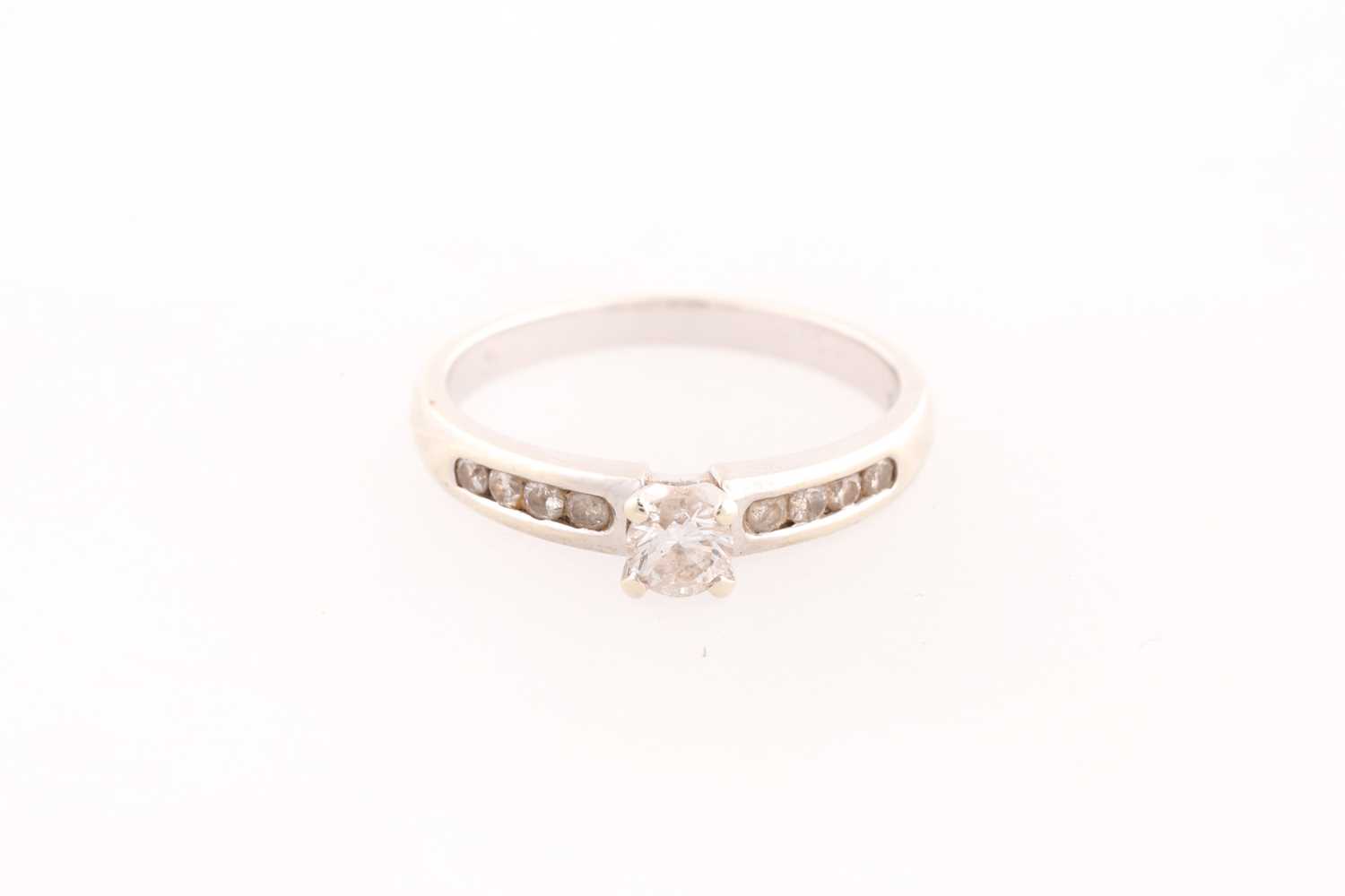 Lot 164 - A single stone diamond ring; the principal...