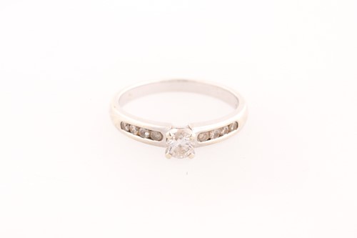 Lot 164 - A single stone diamond ring; the principal...