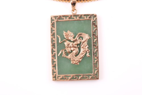 Lot 16 - A yellow metal mounted green jade pendant, the...
